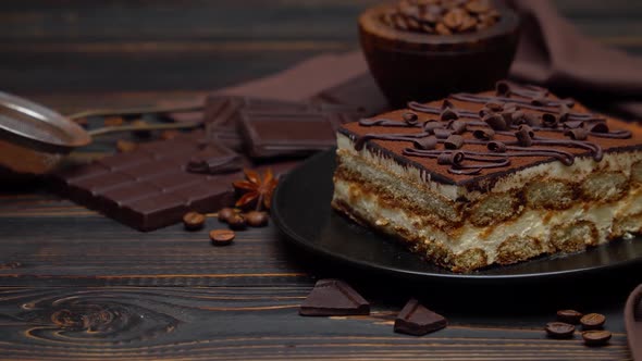 Portion of Traditional Italian Tiramisu Dessert and Pieces of Chocolate Bar