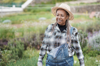 African senior woman gardening - Happy black person enjoy the harvest period at farm / Photodune, Misc