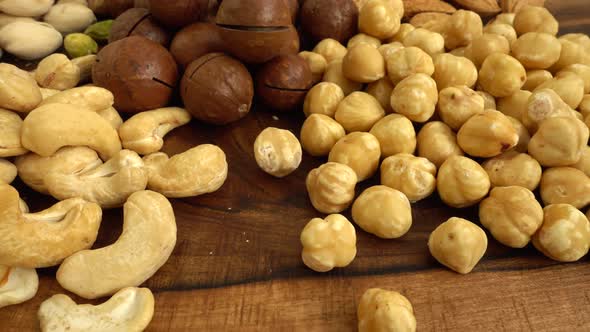 Assorted nuts on a wooden board.