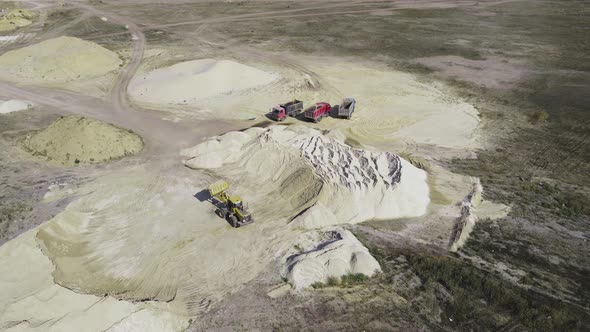 Loader loading sand into a truck body in Sand quarry