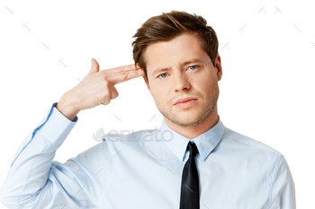  touching his temple with finger gun and looking at camera while standing isolated on white