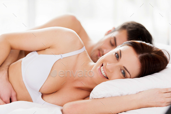 Loving couple in bed. / Photodune