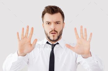 is hands outstretched while standing against grey background