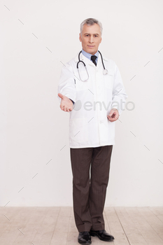 n white uniform looking at camera and stretching out hand while standing isolated on white