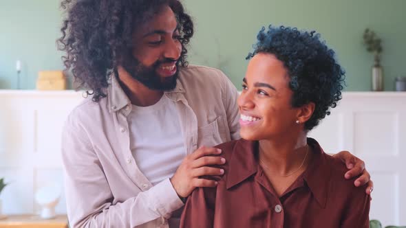 Multiracial Happy Young Couple of African American Woman and Arabian Man at Home