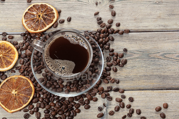 Coffee cup and coffee beans on wooden background / Photodune