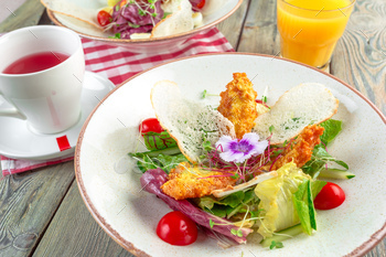 Fresh salad with chicken breast, arugula and tomato. Top view / Photodune