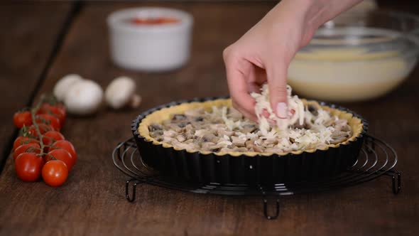 Step By Step Woman Making Quiche Lorraine with Chicken, Mushrooms and cheese.French Cuisine