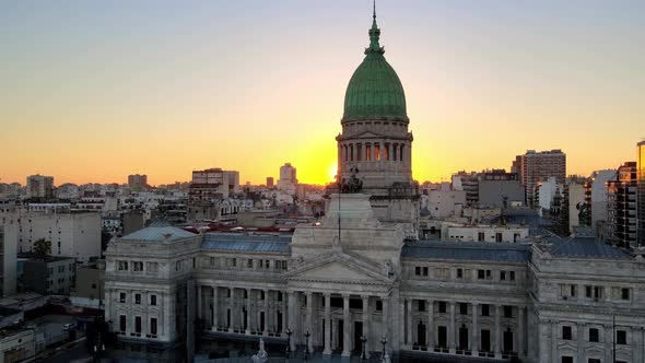 Aerial dolly out of Argentine Congress Palace with green bronze dome at golden hour, Buenos Aires