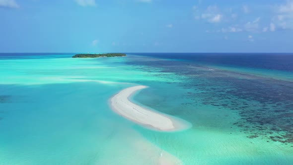 Daytime overhead abstract shot of a sandy white paradise beach and aqua turquoise water background i