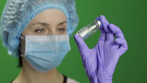 Female Scientist Holding Ampoule in Hand, New Medication Developing, Vaccination