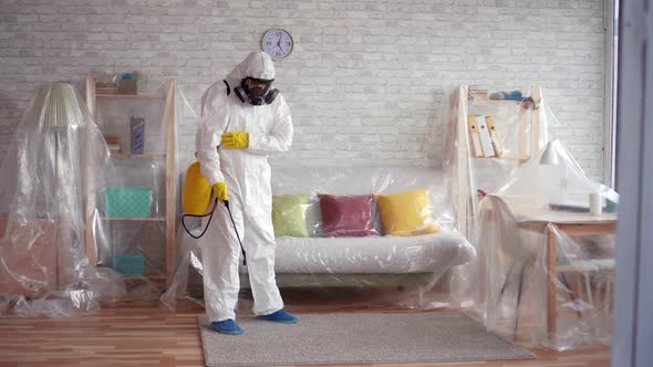 Exterminator Cleans the Carpet with a Spray