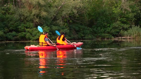 Kayak with a Guy and a Girl Swims on the River. Slow Motion