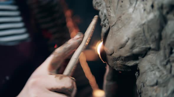 Close Up of a Clay Sculpture Getting Smoothed