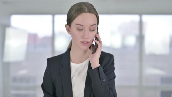 Portrait of Cheerful Young Businesswoman Talking on Smartphone