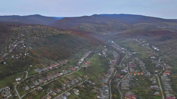 Panorama on small village in a mountain valley of the Carpathian mountains an autumn seasonal time