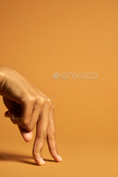 g with the index finger and middle finger isolated over orange background