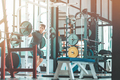 Full-length portrait of young man lifting barbell in the gym. Horizontal shot - PhotoDune Item for Sale