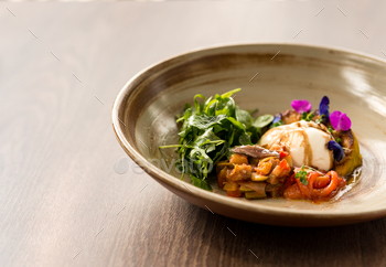 dressed with olive oil, in stylish plate. Healthy, summer food concept. Horizontal shot. Copy space on the left side