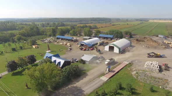 aerial lumber yard vehicles moving and working 4k