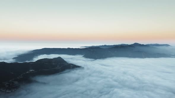 View over clouds and majestic mountains at sunrise in Malibu Canyon, Calabasas, California, USA