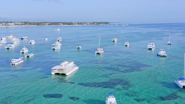 Boats Floating On Shallow Blue Sea In Summer. wide aerial