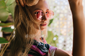 Close-up portrait of adorable tanned girl looking over shoulder. Outdoor shot of blissful woman tou / Photodune