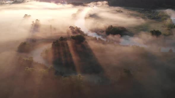 Aerial Drone View of Sunrise Over Misty River