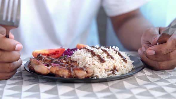 Young Man Waiting for Eating Grill Chicken Rice and Salad on Plate on Table