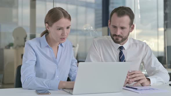 Business People Shocked in Office While  Working on Laptop 