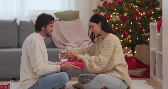 Christmas and New Year Gift Wrapping By Couple at Home During Winter Holidays