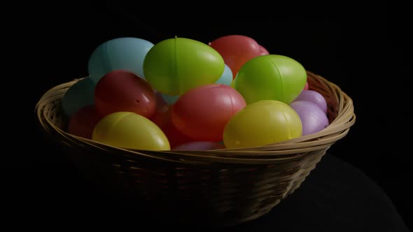 Rotating shot of Easter decorations and candy in colorful Easter grass