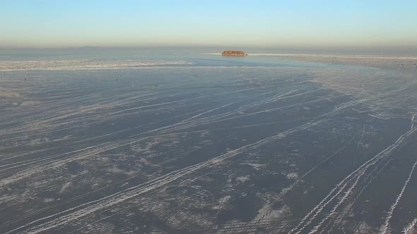 Drone View of a Rocky Island Among the Ice-covered Winter Sea