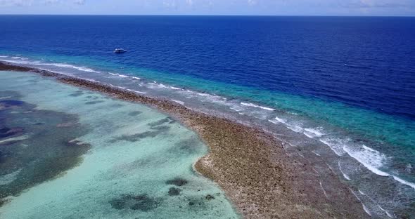 Tropical overhead island view of a white sandy paradise beach and blue water background in colourful