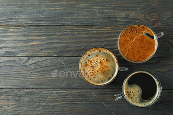 Cups of coffee on wooden background, space for text and top view / Photodune
