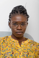 Confident African American female with braided hairstyle and in glasses looking at camera at home - PhotoDune Item for Sale