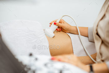 Doctor performs ultrasound examination of a woman / Photodune, Misc