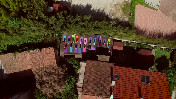 Aerial view of the top of a roof with a group of people doing yoga.