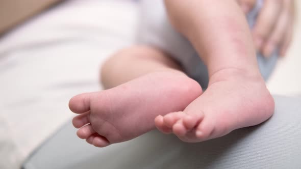 Baby Legs Close Up Loving Mother Feeding Her Little Boy Child Holding on Hands Hugging Baby