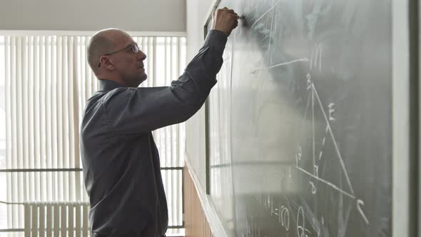 University Professor of Mathematics Writing on Blackboard