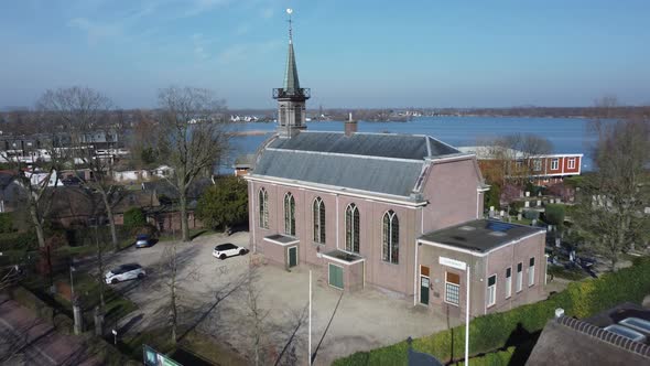 Loosdrechts Church in the Netherlands tilt shot view at Vuntus lake