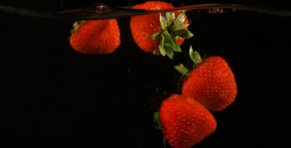 Fresh Strawberries Falling In Water Slow Motion