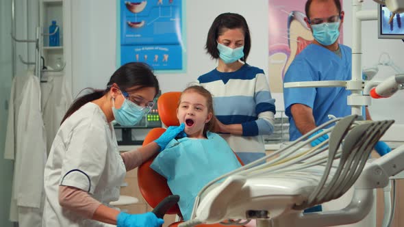 Stomatologist Doctor Checking Tooth Health of Young Patient