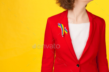 wearing gay pride awareness ribbon on her chest. creative photo.