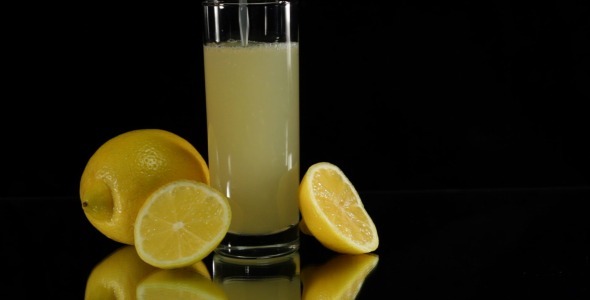 Pouring Citrus Juice on Black