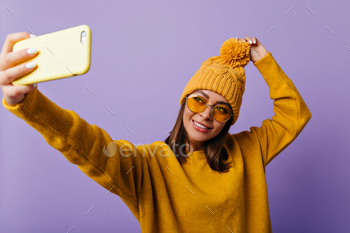  her yellow iphone. Portrait of slavic student in good mood on isolated background