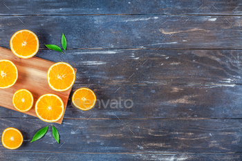 Fresh oranges on dark wooden background / Photodune