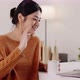 Young modern Asian woman works from home with laptop computer in living room. - VideoHive Item for Sale