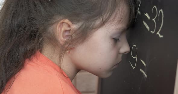 Schoolgirl with Maths on Chalkboard