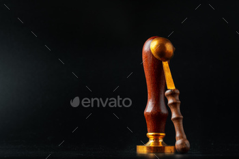 Wax seal stamp on dark black background / Photodune, Misc